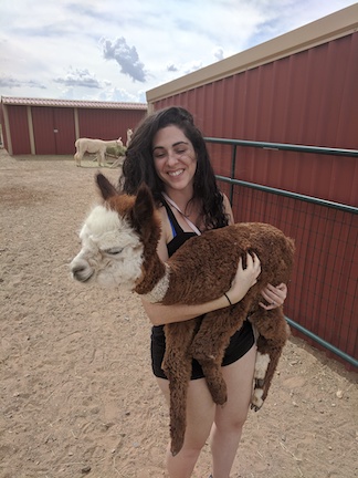 Dana holding a baby alpaca